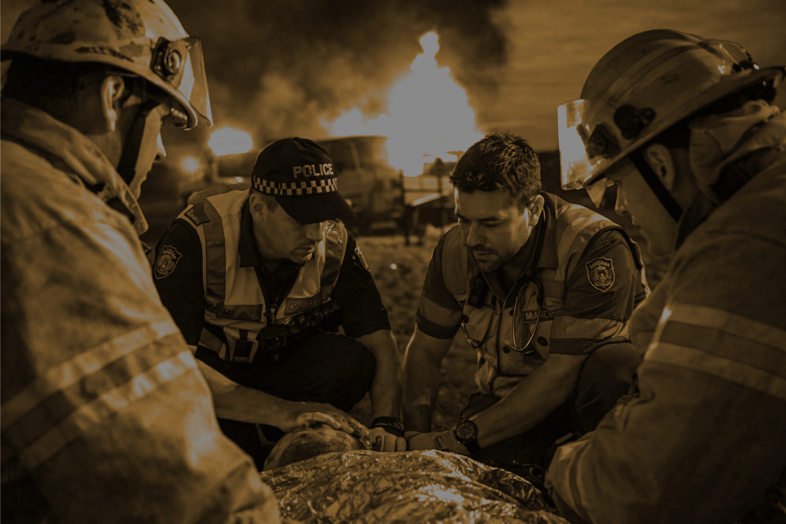 First responders including police, firefighters, and paramedics providing aid at an emergency scene